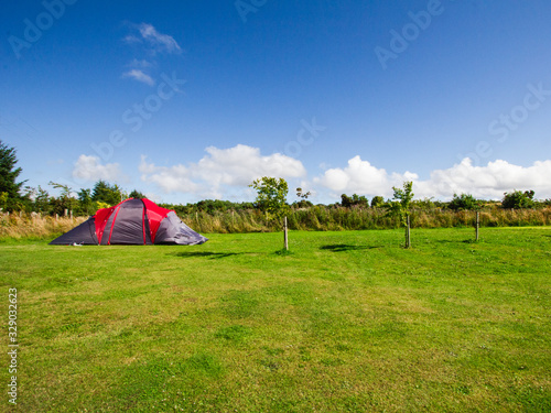 Tourist tent on a green field at European camping