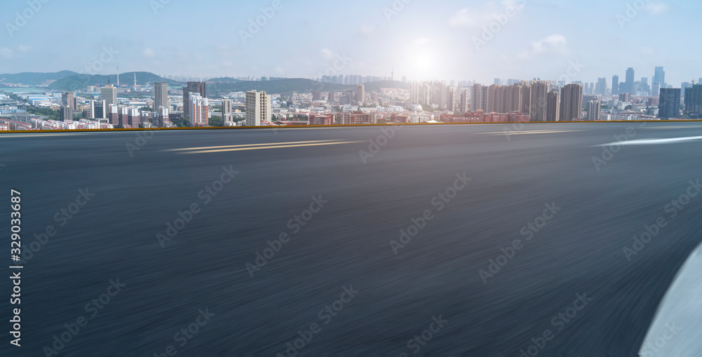 Asphalt road and Qingdao urban construction skyline..