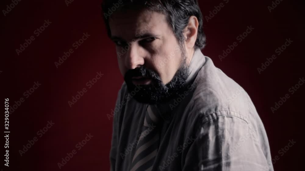 A depressed man, showing resistance to the events. Shot with artistic intentional darkness and contrast. Part of a series of depictions of feelings and emotions with professional actors. A depressed man, showing resistance to the events. Shot with artistic intentional darkness and contrast. Part of a series of depictions of feelings and emotions with professional actors.