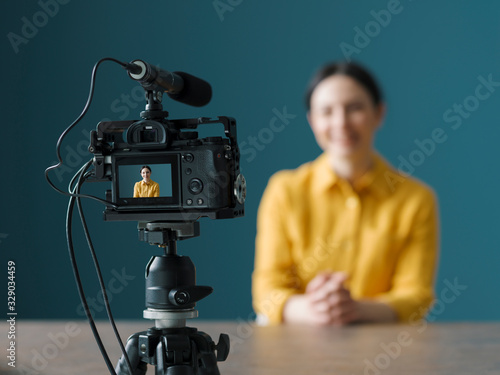 Professional vlogger sitting in front of a camera photo