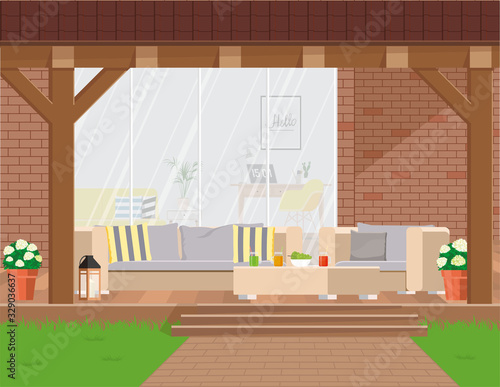 Cozy garden corner with outdoor furniture under a canopy against the backdrop of a panoramic window.