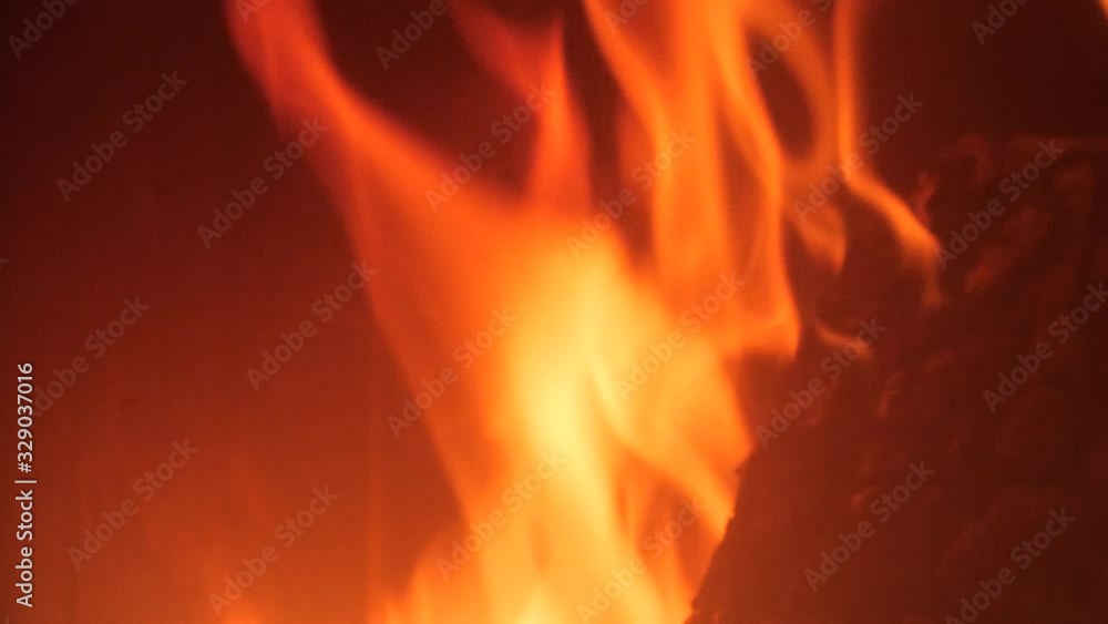 firewood burns in the fireplace with red tongues of flame firewood burns in the fireplace with red tongues of flame