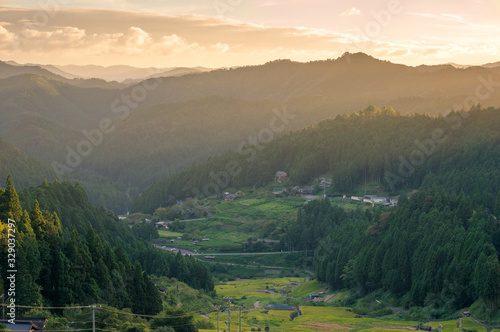 Mountain landscape with rice terraces at sunset. Japanese countryside
