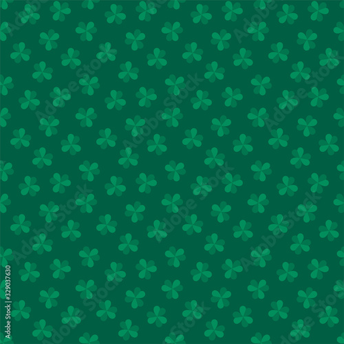 St. Patrick's Day background. Seamless pattern of clover leaves on dark green background. Illustration in flat style. Vector 8 EPS.
