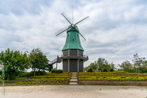 Windmill tower with blue roof. Tsuchiura public park grounds in Japan photo