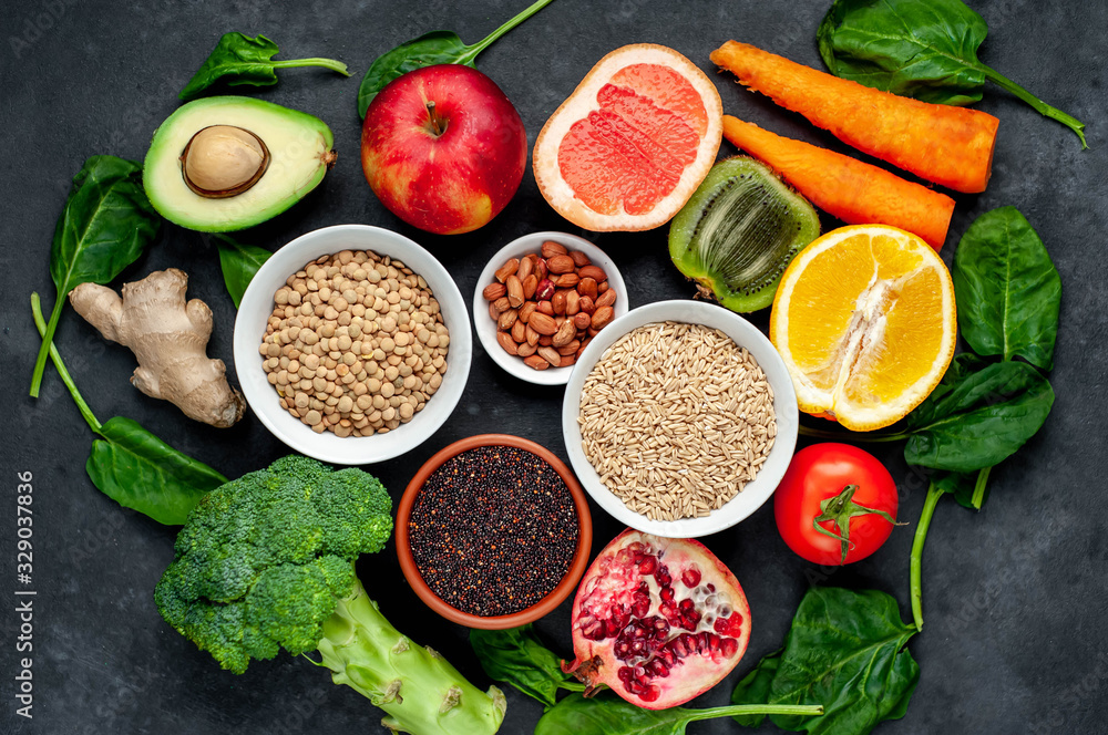 Selection of healthy food: fruits, seeds, cereals, superfoods, vegetables, leafy vegetables on a stone background. Healthy food for humans Selection of healthy food: fruits, seeds, cereals, superfoods, vegetables, leafy vegetables on a stone background. Healthy food for humans