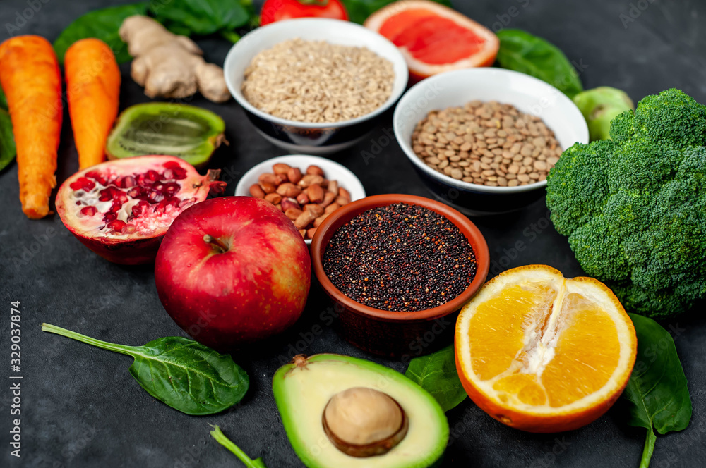 Selection of healthy food: fruits, seeds, cereals, superfoods, vegetables, leafy vegetables on a stone background. Healthy food for humans Selection of healthy food: fruits, seeds, cereals, superfoods, vegetables, leafy vegetables on a stone background. Healthy food for humans