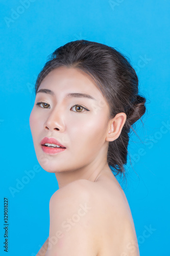 The beauty of women with perfect skin health images Touching her face and smiling like a spa to pamper her skin Blue background