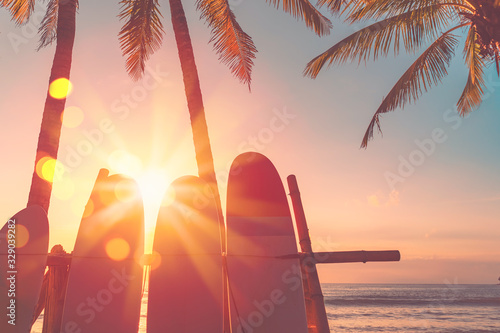 Deska surfingowa i palmy na tle plaży.