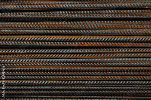 Reinforcing bars with a periodic profile in the packs are stored in the metal products warehouse. Background for photo collages