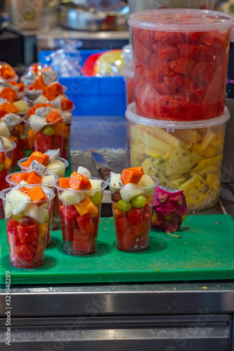 Fresh fruit cups prepared for sale in restaurant's kitchen