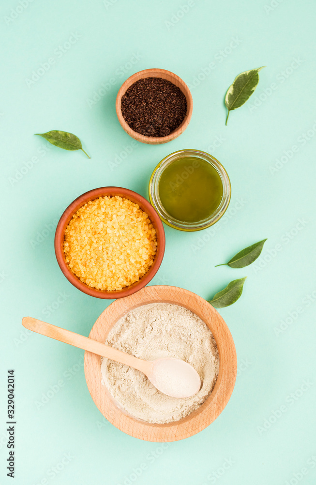 Cosmetic bath salt, grape gomaj for the face, coffee scrub for the body on a mint background. Spa cosmetic, zero waste. Cosmetic bath salt, grape gomaj for the face, coffee scrub for the body on a mint background. Spa cosmetic, zero waste.