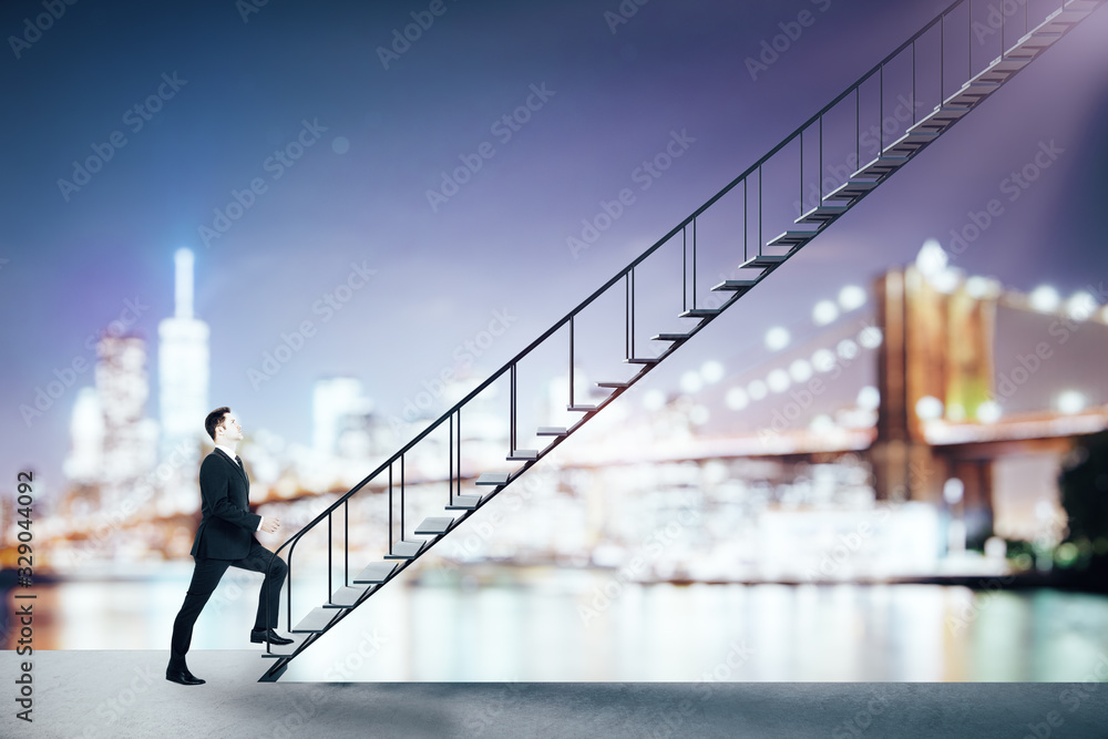 Businessman rises up on interfloor stairs