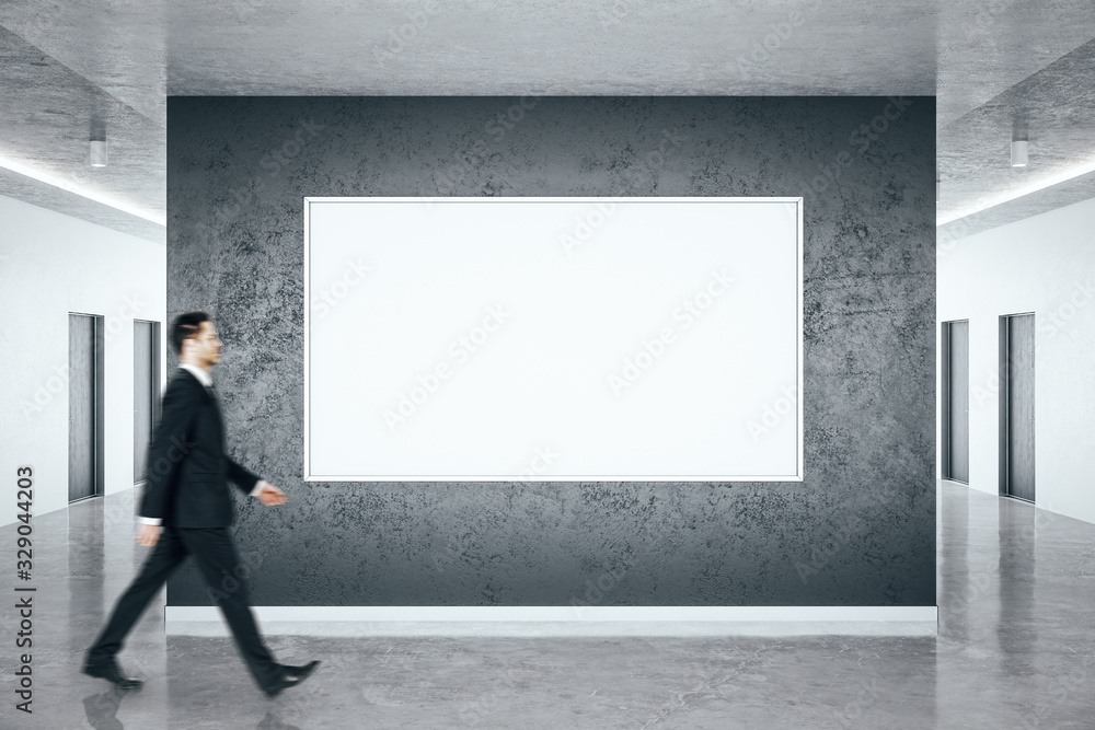 Businessman walking in minimalistic hall interior Businessman walking in minimalistic hall interior