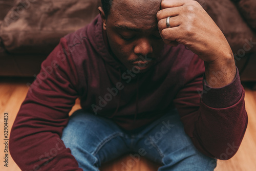 Konstfotografi black african american man depicting a sad depressive state, depression concept
