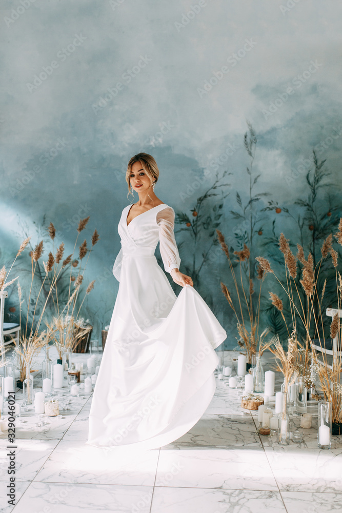 Decor of dried flowers at the ceremony in the European style.Portrait of a beautiful young bride in a wedding dress. Decor of dried flowers at the ceremony in the European style.Portrait of a beautiful young bride in a wedding dress.