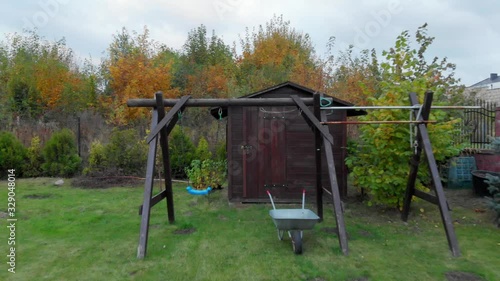 Wallpaper Mural Child's empty swing and a barrow in the backyard. Torontodigital.ca