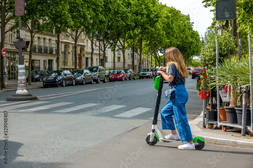 Girl on an Electric Scooter at the Crossroads of Paris