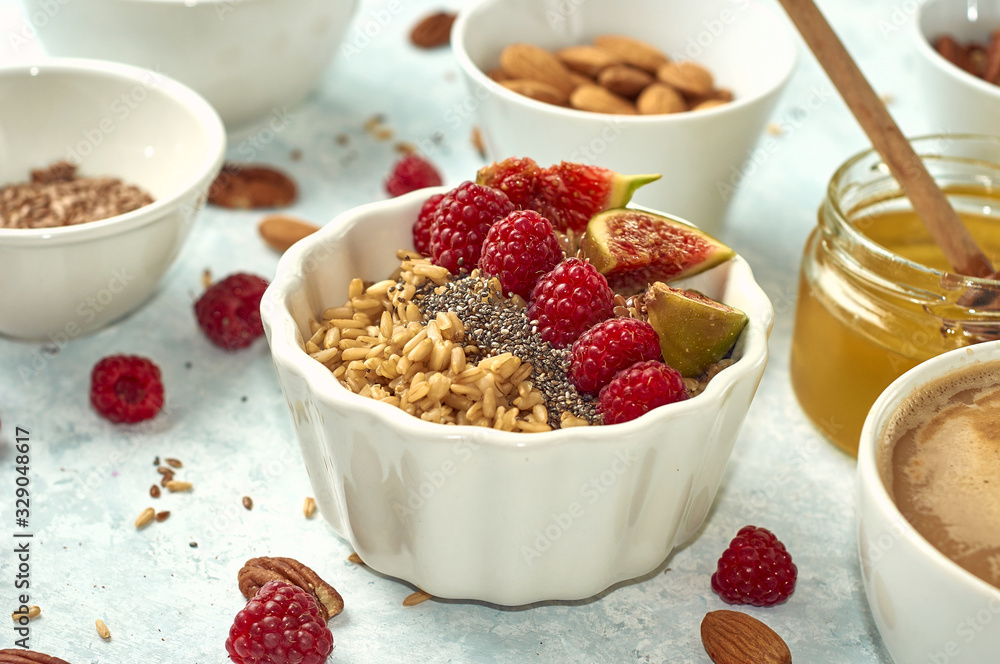 healthy breakfast, oatmeal with raspberries and honey, top view healthy breakfast, oatmeal with raspberries and honey, top view
