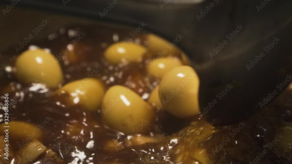 Close up of Boiled Egg and Pork in Sweet Brown Sauce. Boiling. Slow motion Close up of Boiled Egg and Pork in Sweet Brown Sauce. Boiling. Slow motion
