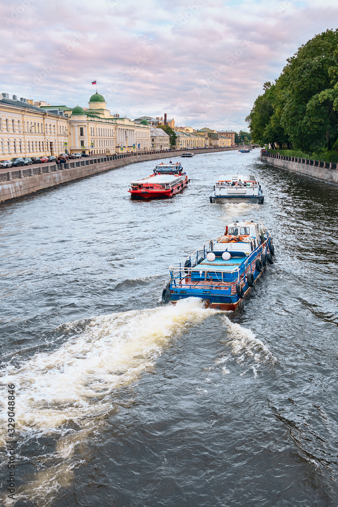 View of the Fontanka River with pleasure boats and the embankment in St. Petersburg, Russia