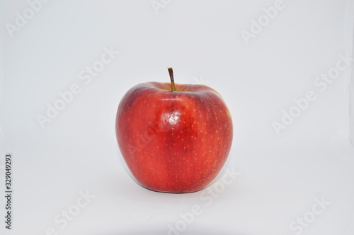  red, ripe, juicy apple on a white background. apple is a source of iron, vitamins and minerals