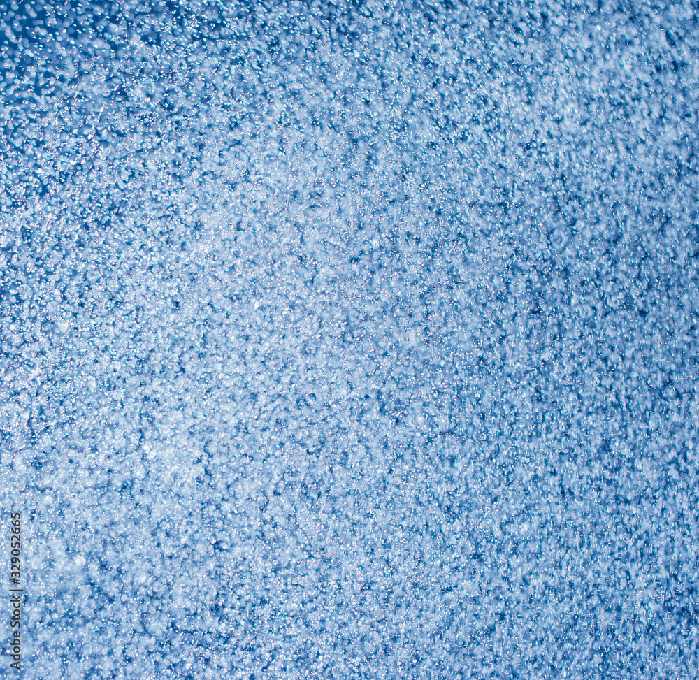 clear and fuzzy drops of water on a blue background