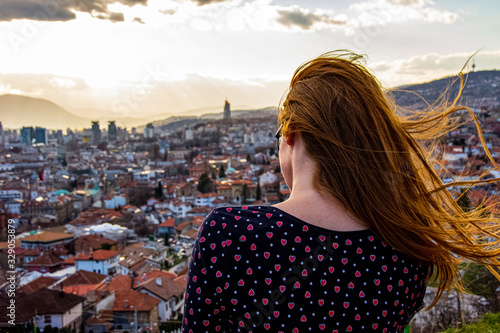 Girl looking to the city of Sarajevo from Yellow bastion shooted from behind