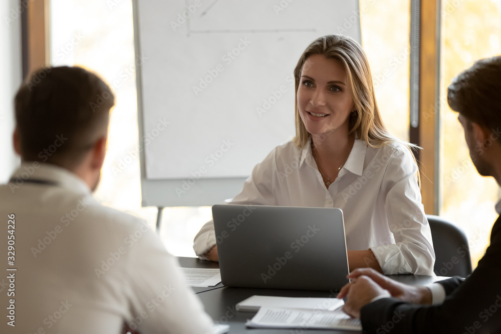 Head shot happy female team leader taking part at business meeting, listening to colleagues opinion, satisfied with first project results. Diverse teammates discussing new ideas, planning strategy. Head shot happy female team leader taking part at business meeting, listening to colleagues opinion, satisfied with first project results. Diverse teammates discussing new ideas, planning strategy.