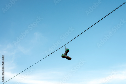 sneakers hung on an electric cable