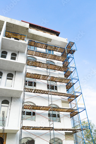 Extensive scaffolding for building a new house. Constraction of platforms for building works © sosiukin