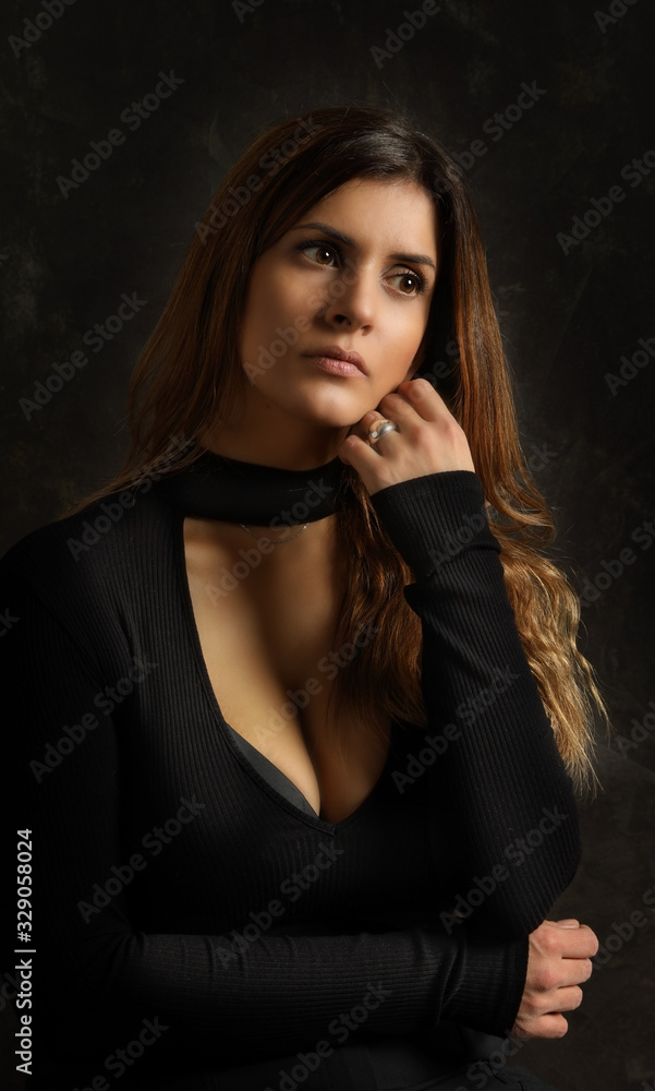 Portrait of a beautiful young brunette woman in a black dress Portrait of a beautiful young brunette woman in a black dress