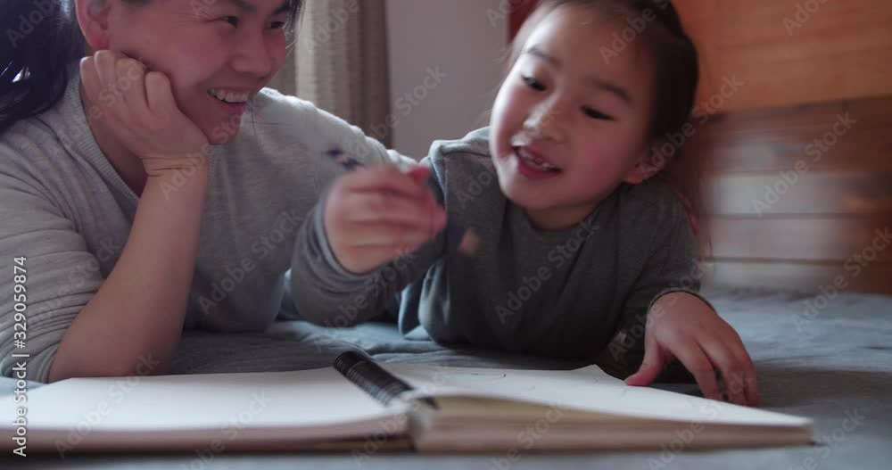 Happy asian little girl talking to her mother at home sharing ideas with painting home education parent kid communication concept 4k slow motion footage Happy asian little girl talking to her mother at home sharing ideas with painting home education parent kid communication concept 4k slow motion footage
