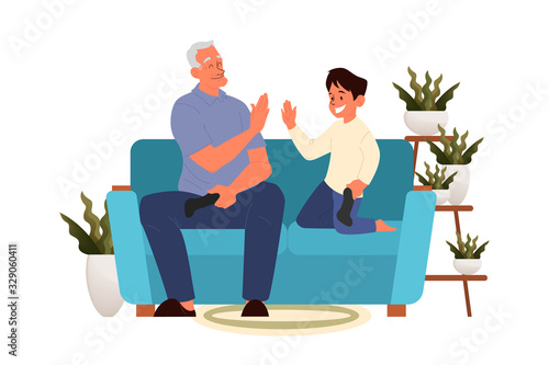 Old man playing video games with his grandson. Senior playing video