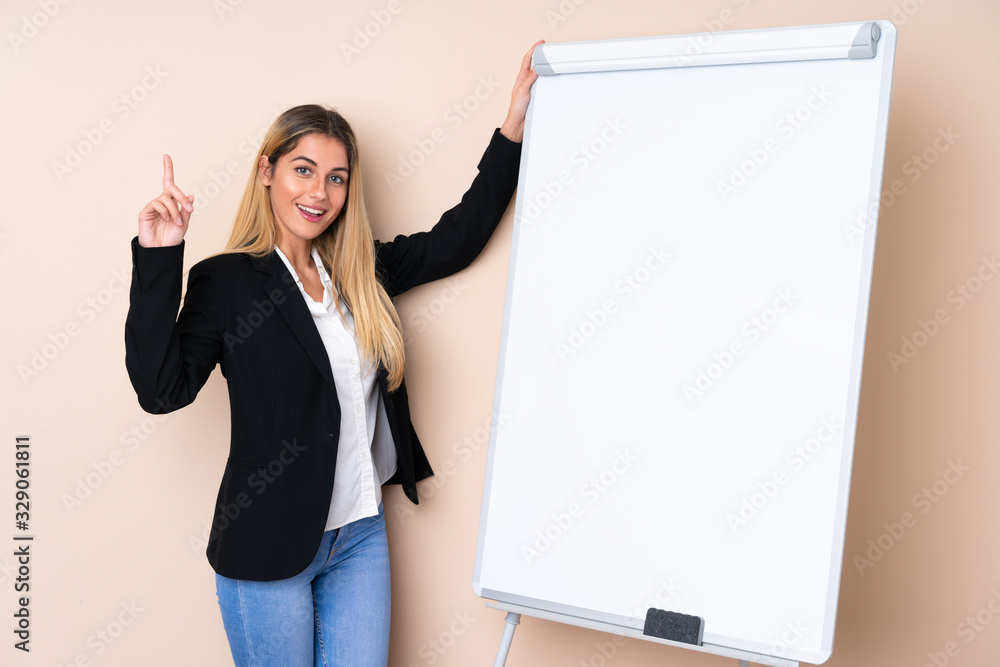 Young Uruguayan woman giving a presentation on white board with thumb up Young Uruguayan woman giving a presentation on white board with thumb up