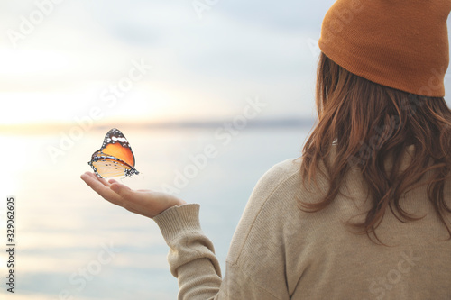 Photography delicate moment  between a butterfly and a woman