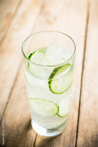 Detox beverage with cucumber slices on the rustic background. Selective focus. Shallow depth of field.