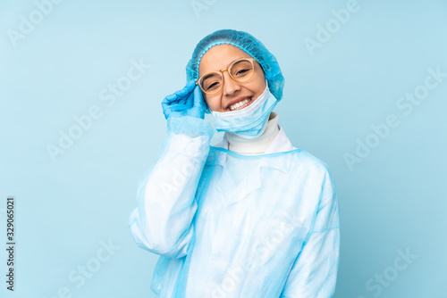 Young surgeon Indian woman in blue uniform with glasses and happy © luismolinero