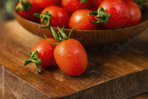 The cherry tomato is a type of small round tomato believed to be an intermediate genetic admixture between wild currant-type tomatoes and domesticated garden tomatoes. with white background.