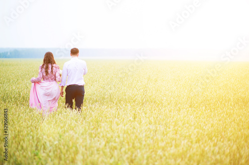 Beautiful couple just married on the field of wheat. Muslim marriage