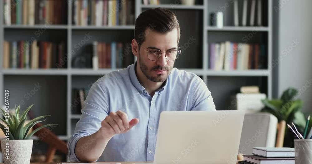 Stressed business man feels frustrated by data loss using laptop at work. Shocked male user looks at computer screen reads bad news, has unexpected online website problem sitting at home office desk.