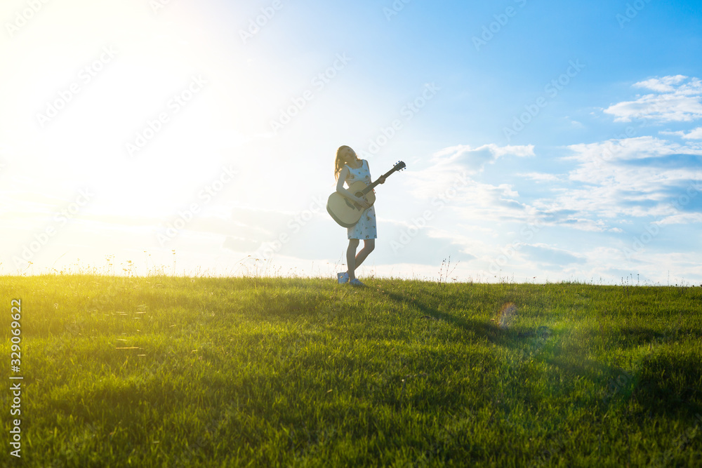 Women with guitar over sunset sky, Selective Focus. Women with guitar over sunset sky, Selective Focus.