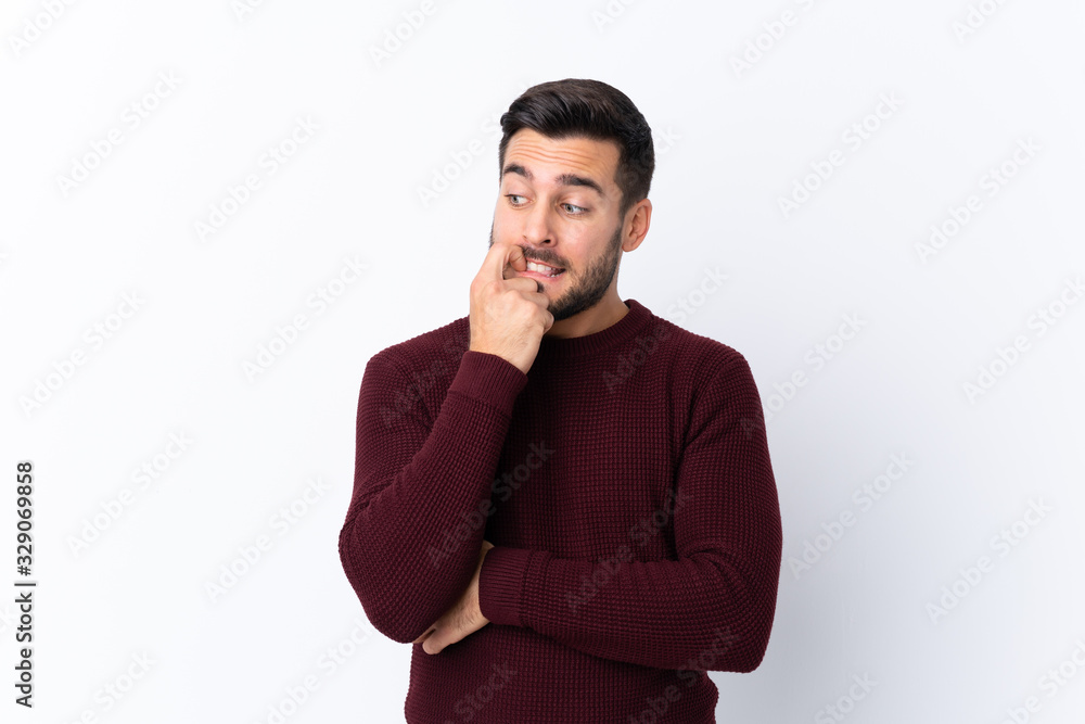 Young handsome man with beard over isolated white background nervous and scared Young handsome man with beard over isolated white background nervous and scared
