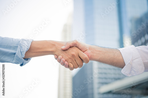 Successful businessman handshaking after good deal.