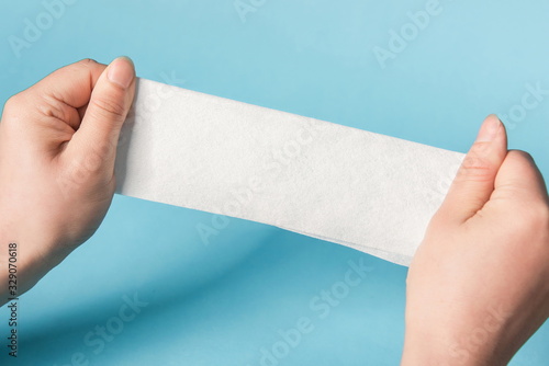 One hand is testing the tenacity of a tissue