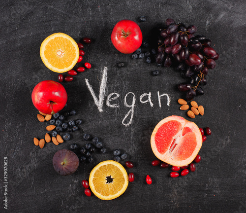 Mixed healthy fruit over a blackboard background. Concept pf vegan and genuine fruit