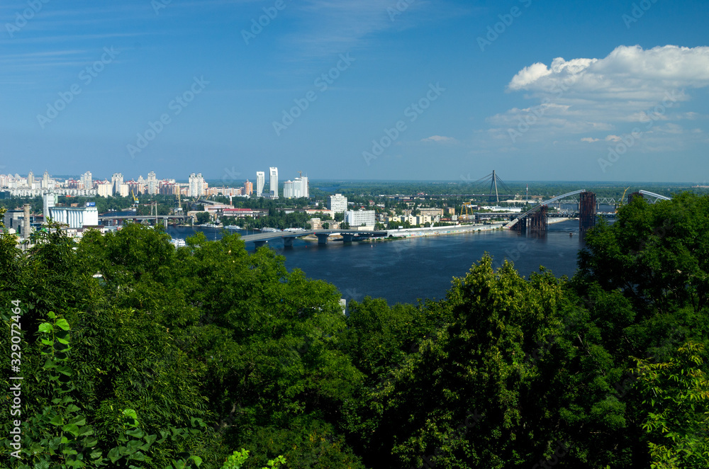 Panorama of the city of Kiev, view of the Dnieper River and forest. Construction of a new arch bridge over the river. The capital of ancient Russia. Kyiv, Ukraine, July 4, 2015