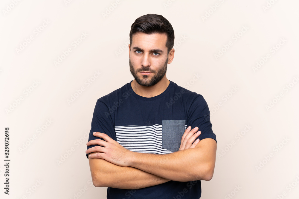 Fototapeta premium Young handsome man with beard over isolated background feeling upset