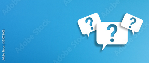 Question marks with speech bubbles on blue background	 photo