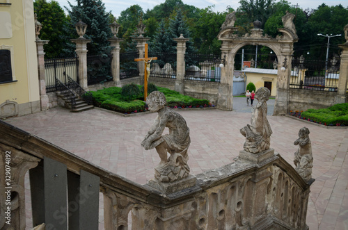 Cathedral of St. George in Lviv. Ancient Europe. Yellow building in Baroque style with stucco and sculptures. Stone decorative statues. Lviv, Ukraine, July 18, 2017 photo